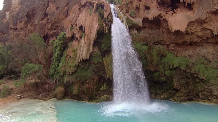A waterfall flows into a lake
