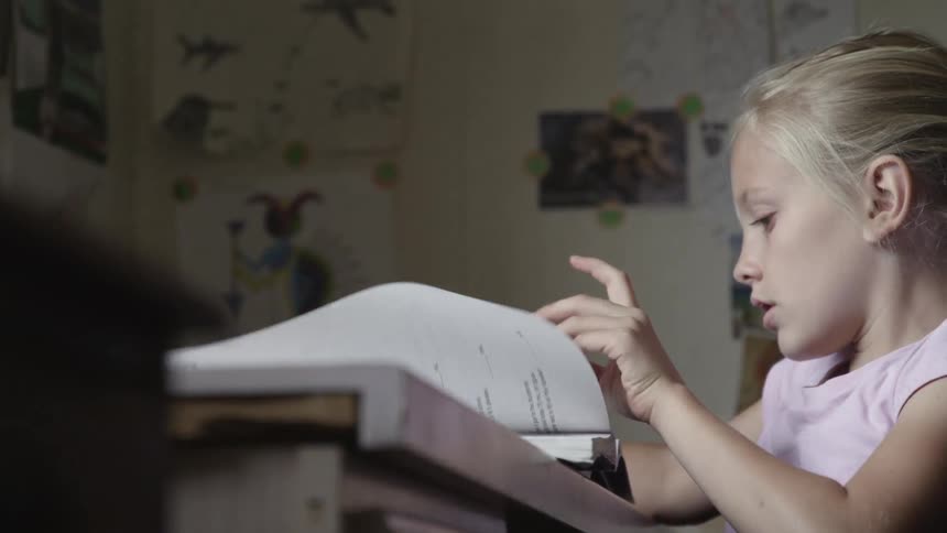 Girl sitting at desk doing school work