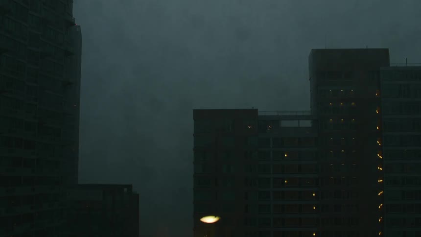 Time lapse of storm clouds moving over a city skyline