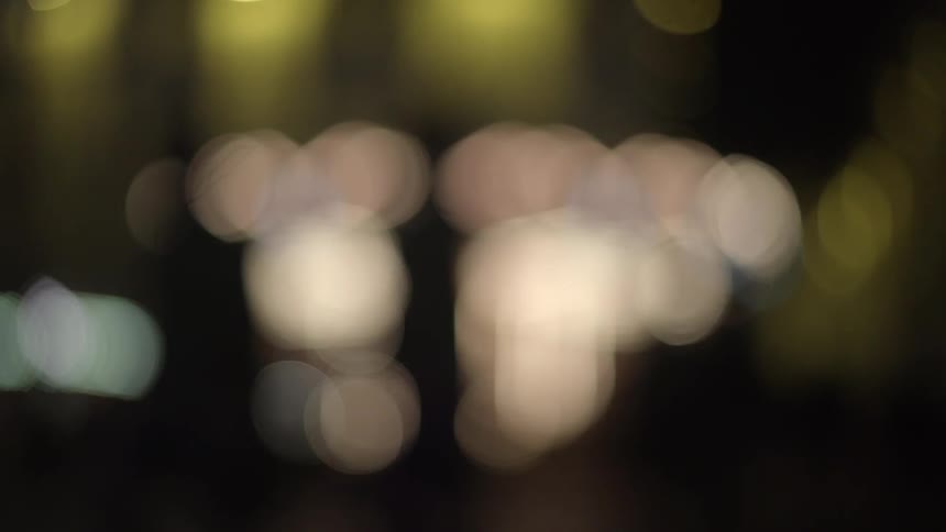 Lights circle, while people walk past