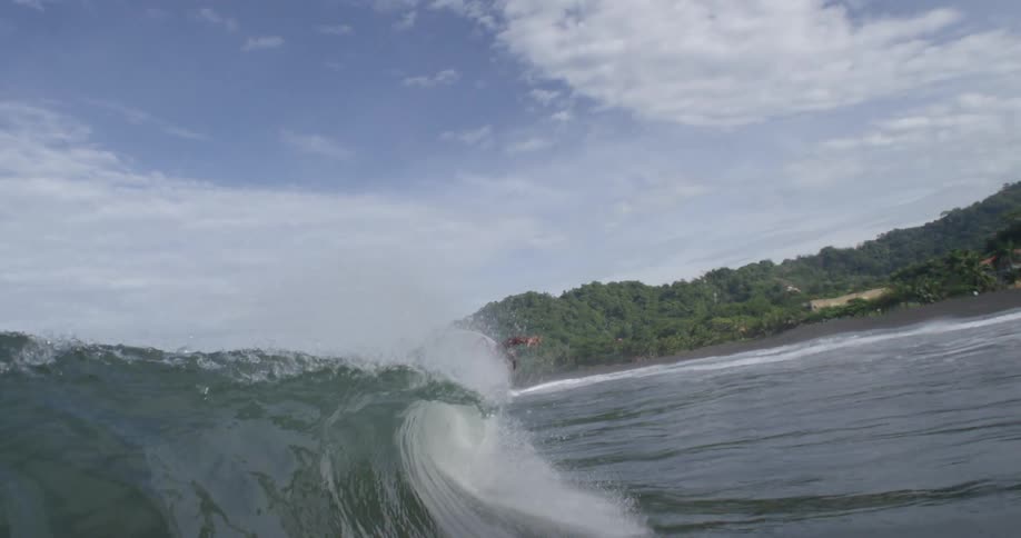 A surfer rides an ocean wave