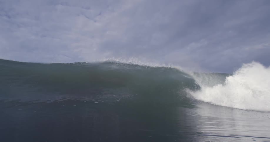 A large wave crashes over itself