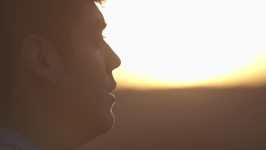 A man looks into the sunset