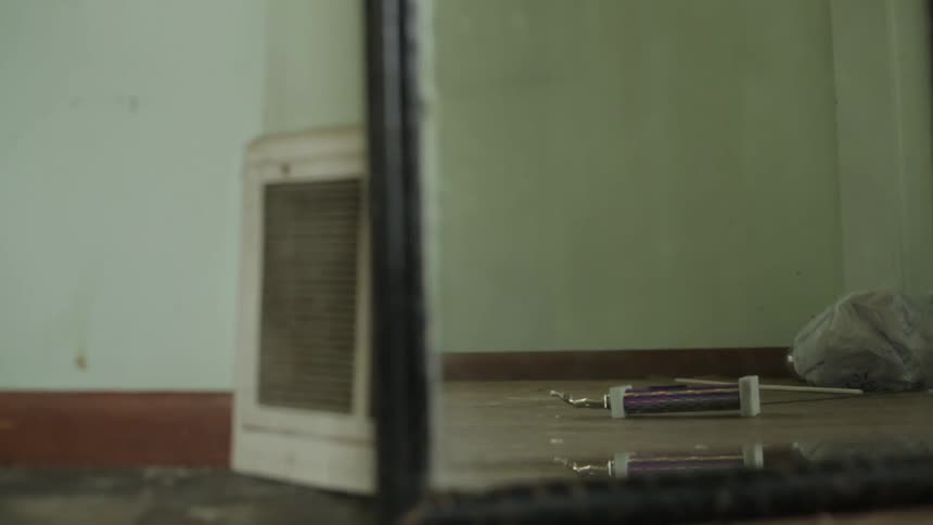 A mirror stands in an empty room
