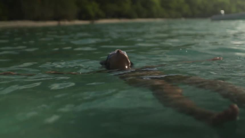 Person floating in the water on a sunny day