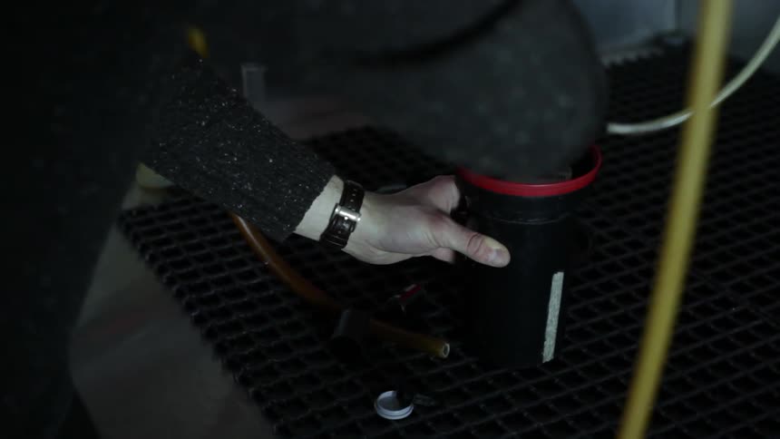 A man puts parts together to form a product