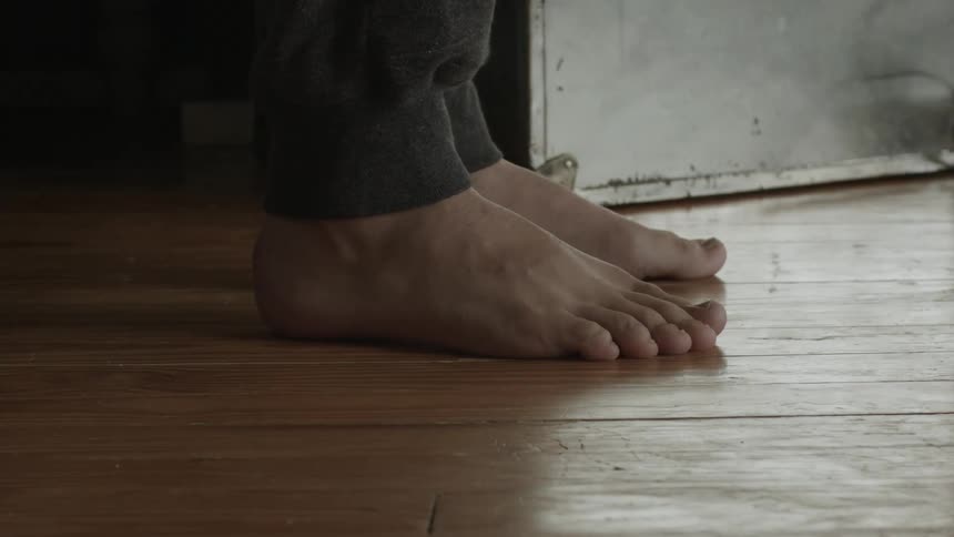 Persons feet hitting a wood floor