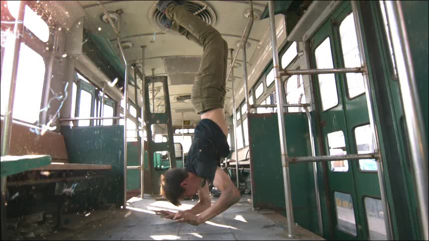 A person doing a trick on a bus
