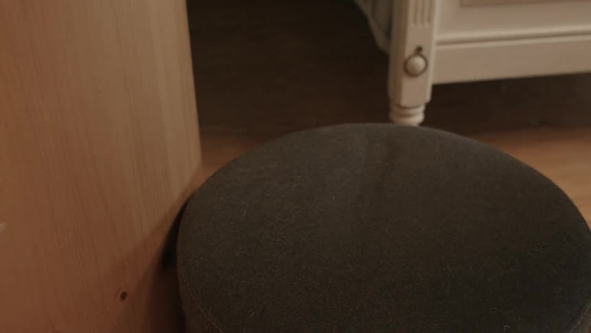 Light brown weather bag being picked up off of a stool