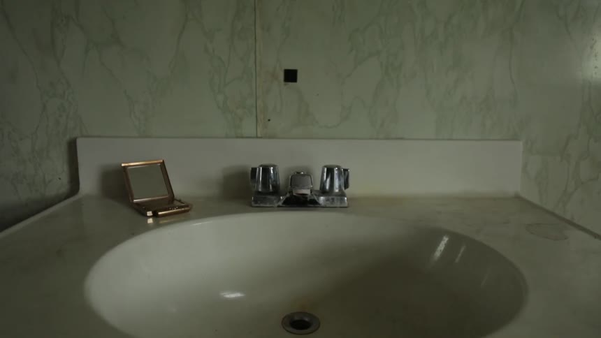 A bathroom sink sits undisturbed