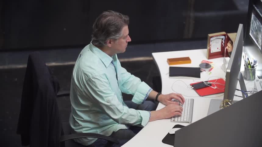 Man working on computer sitting at desk
