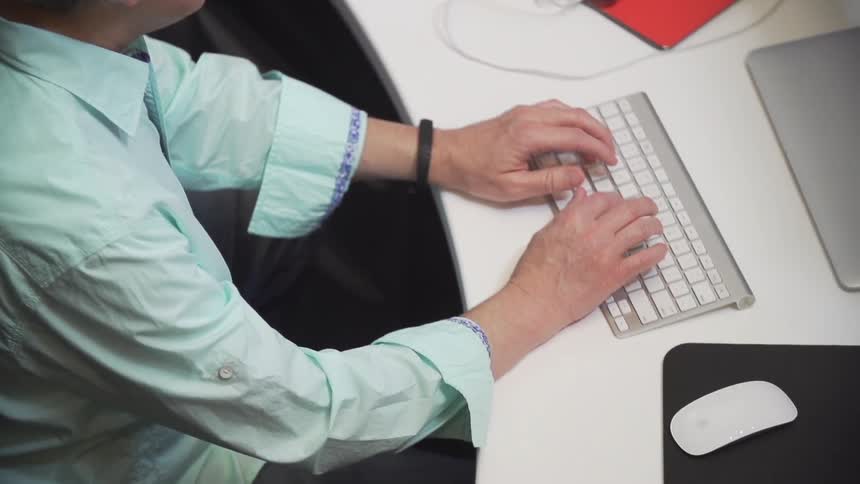 A person typing on a keyboard