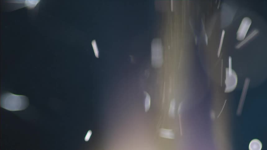 Sparks flying from below in a dark area