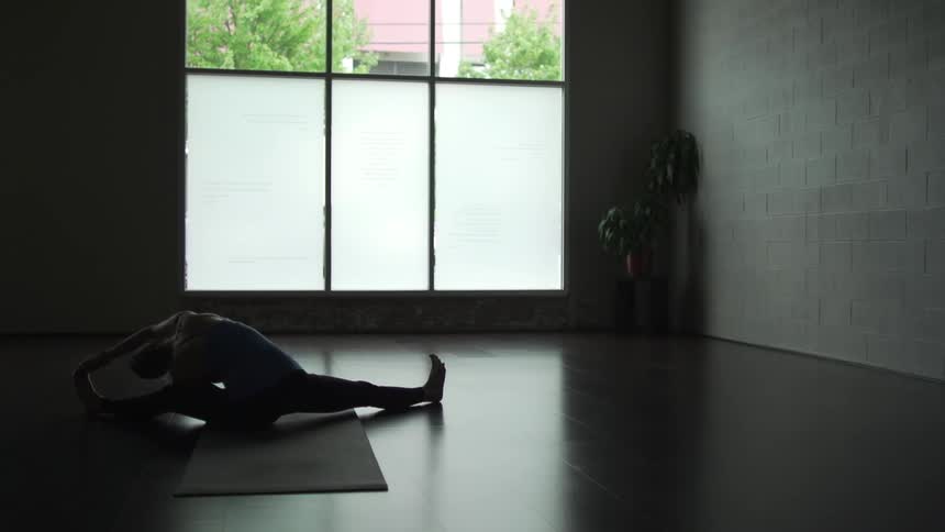 A woman does yoga alone