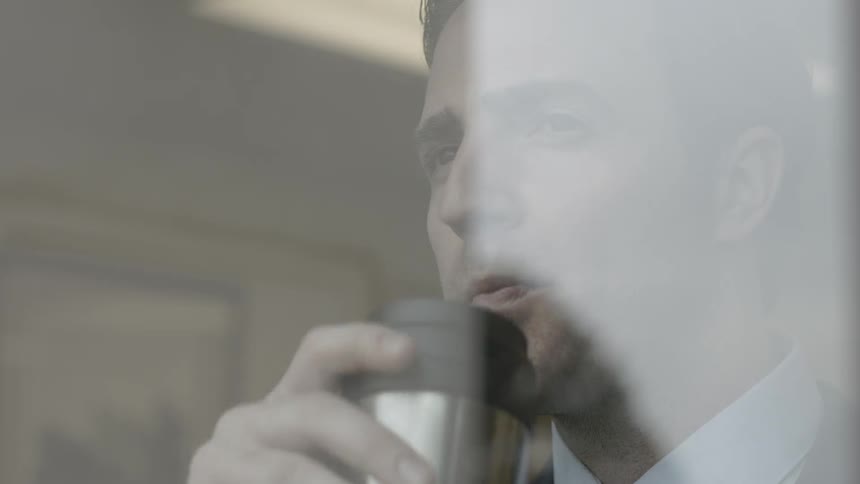 A man looks out a window