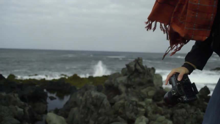 A woman is photographing waves