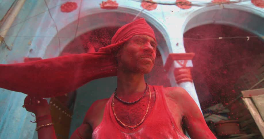 A person removing a face cover