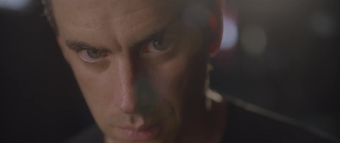 A man stares intently and then looks up