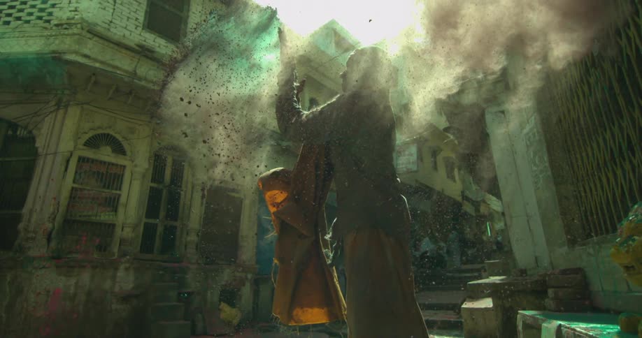 Person flinging dirt into the air