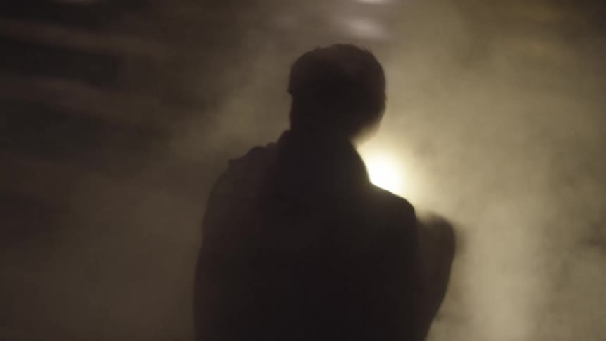 A person sitting next to smoke