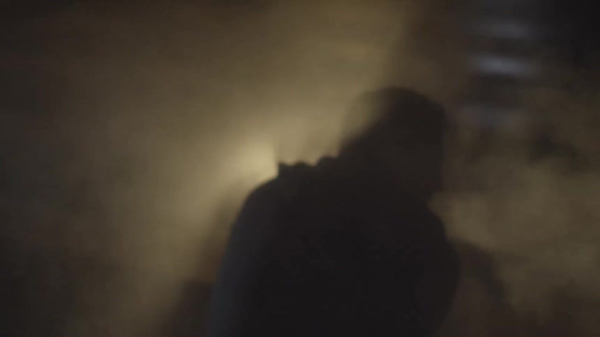 A person sitting next to some smoke