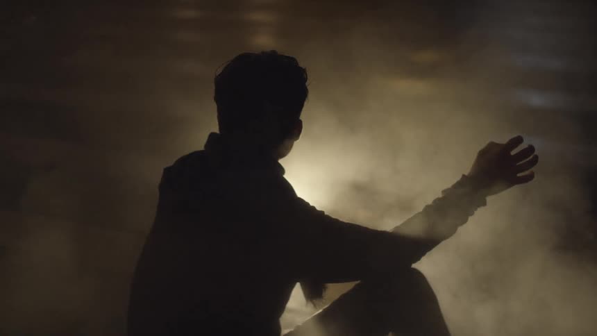A person sitting next to some smoke
