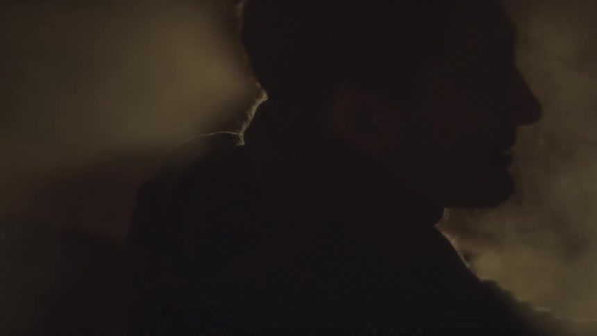 Smoke circling around a man in the dark