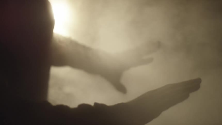 Steam surrounding silhouetted hands