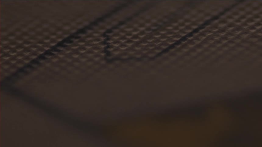 The colored lines of a logo or painting on a woven surface