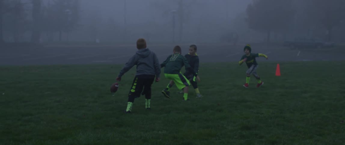 Kids playing football on a foggy day
