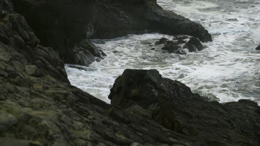 Waves beat against a rocky beach