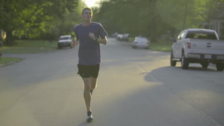 A man jogs down the street