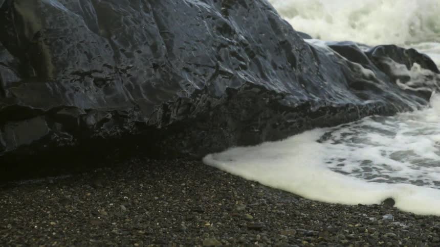 Waves crash on a rocky beach