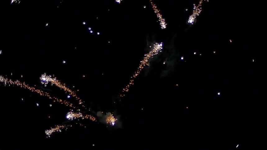 Fireworks explode in the dark night sky
