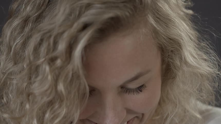 A woman smiles and laughs