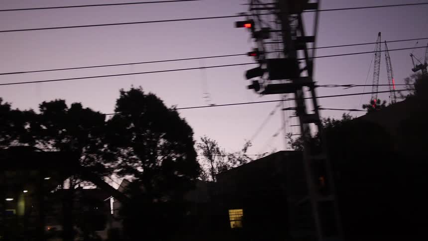 Electrical lines run alongside a road at dusk