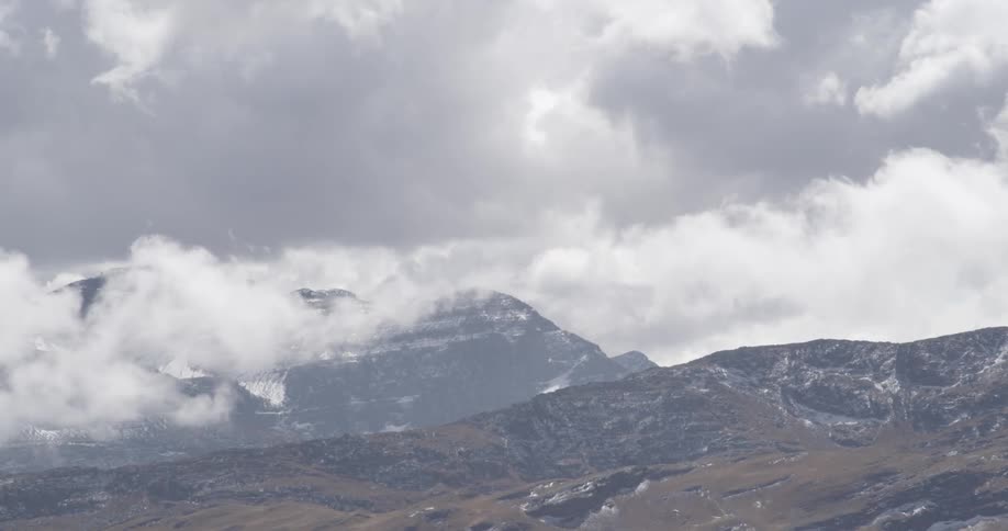 Clouds float over a mountain range