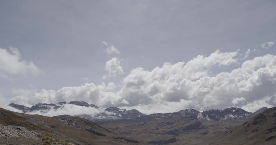 Clouds creep over a mountain range