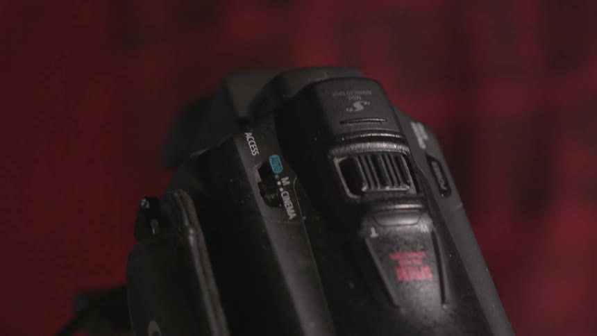 A man turns on a video camera