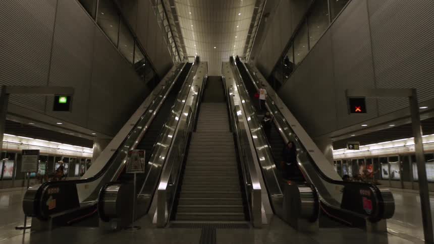 People moving down an escalator