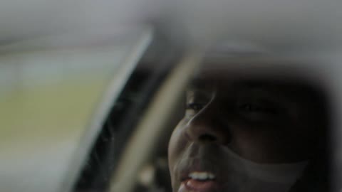 A man rides in a vehicle