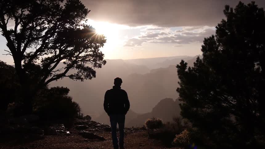 A man is walking along a ridge