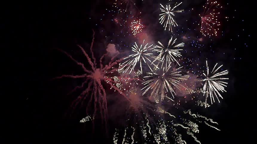 A firework explodes in the dark night sky