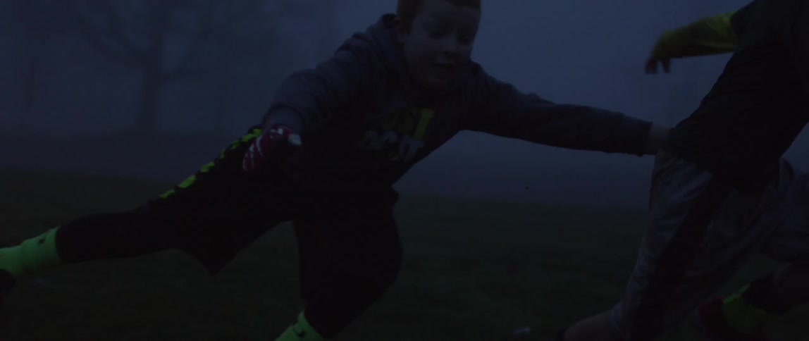 Boys playing ball in the dark