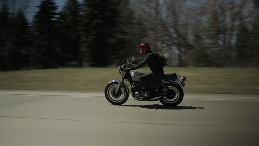 A man is driving a motorcycle