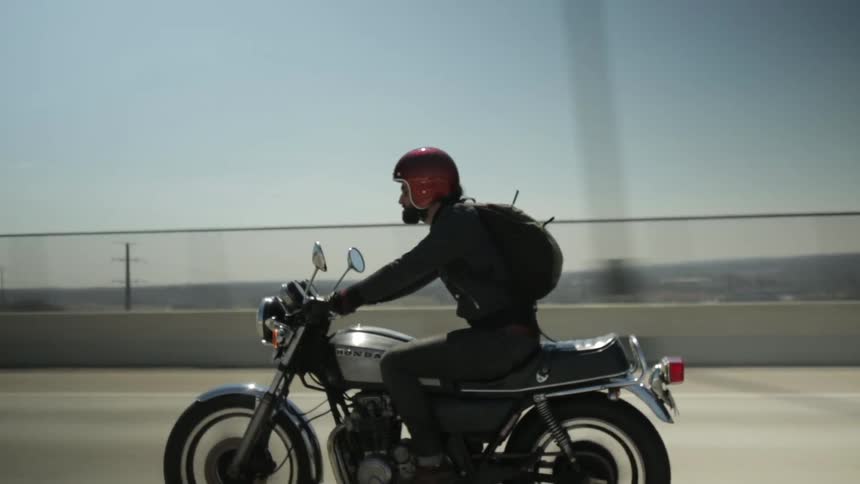 Man riding a motorcycle on a freeway