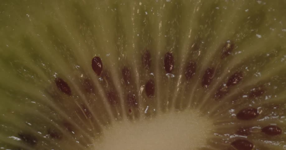 A cut kiwi is rotating