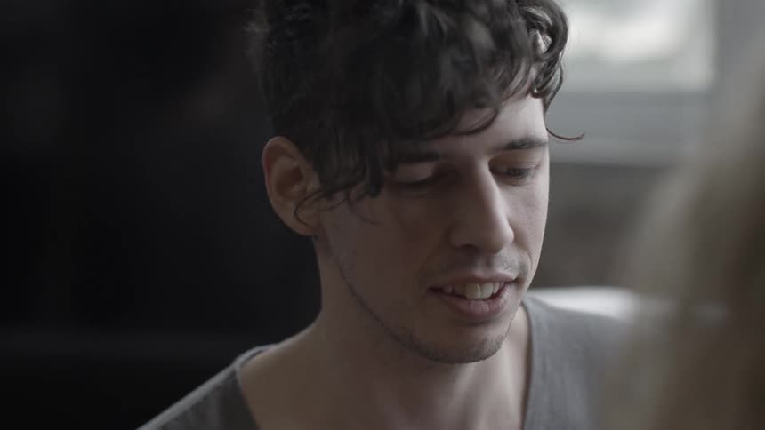 A man smiles and laughs