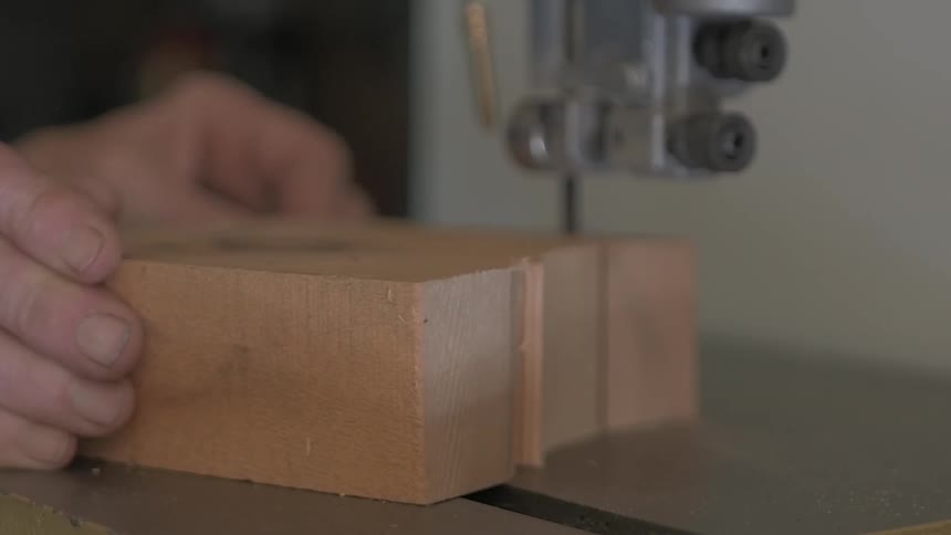 A person cutting a block of wood