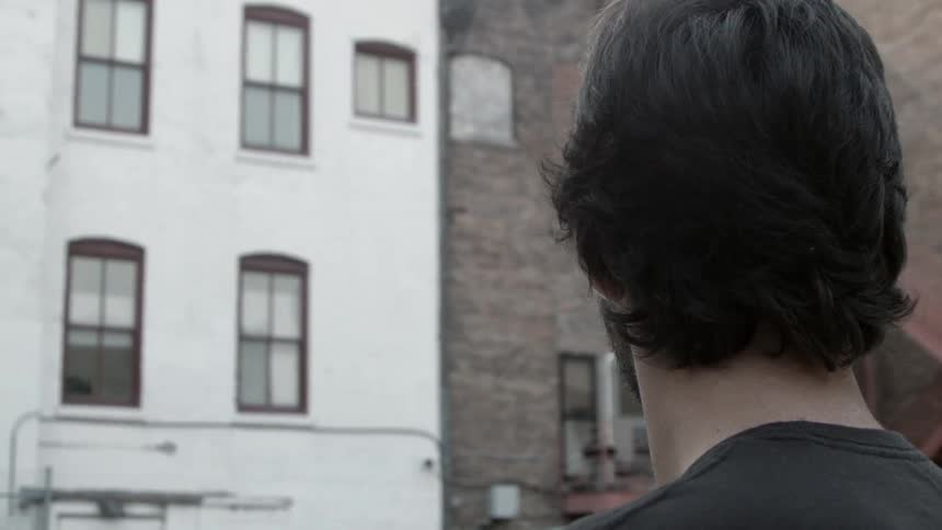 Man standing and looking at buildings